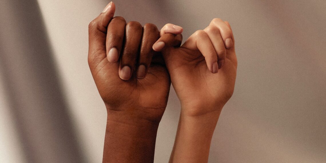 persons hand with white manicure