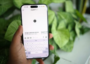 a person holding a cell phone in their hand