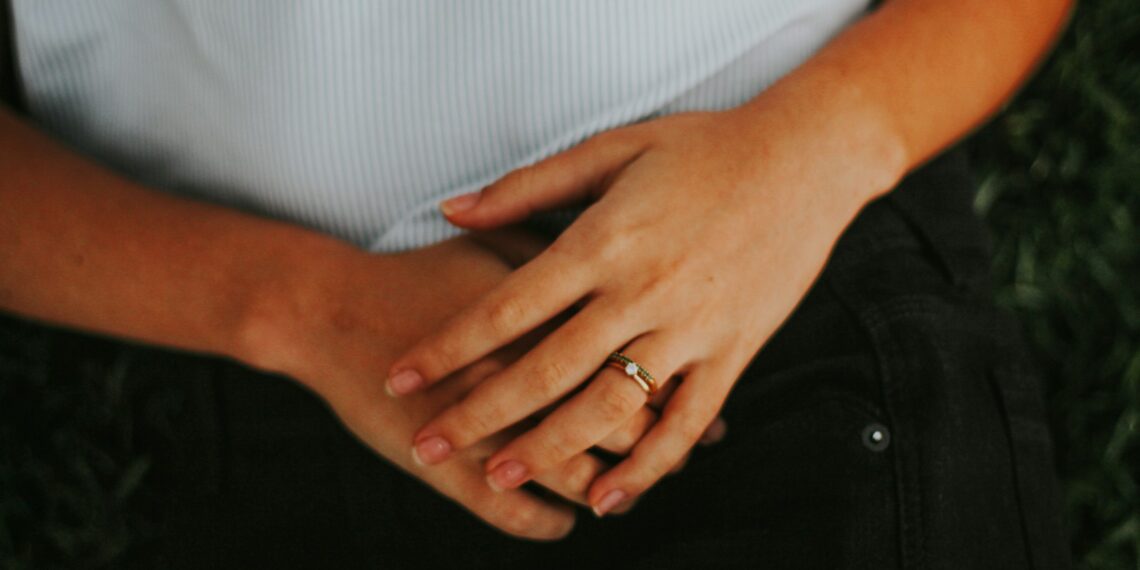 person wearing silver ring and white shirt