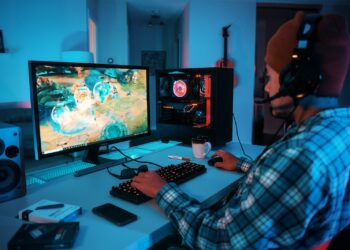 a person wearing headphones and using a computer