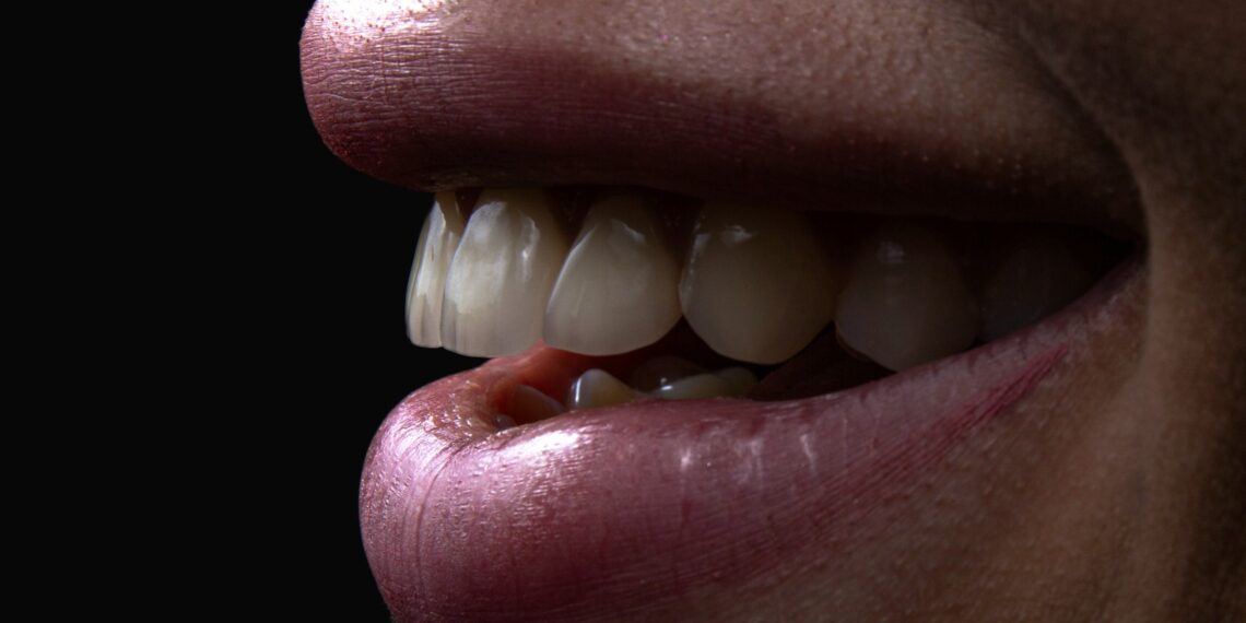 a person's mouth with teeth and a group of white balls