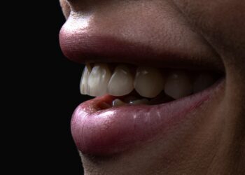 a person's mouth with teeth and a group of white balls