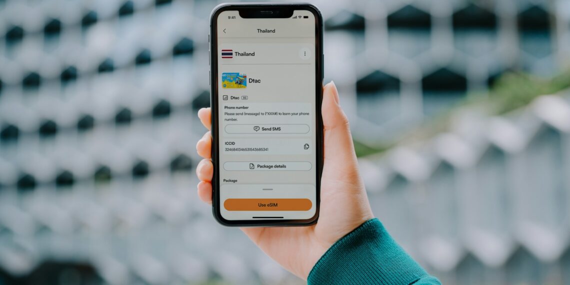 Hand holding a smartphone displaying a payment app.