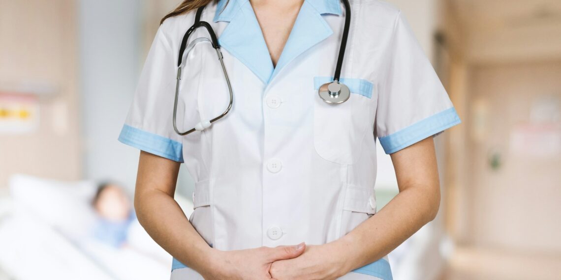 woman in white button up shirt and blue stethoscope