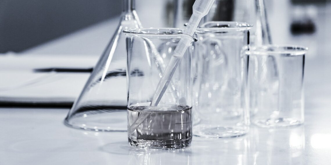 three clear beakers placed on tabletop