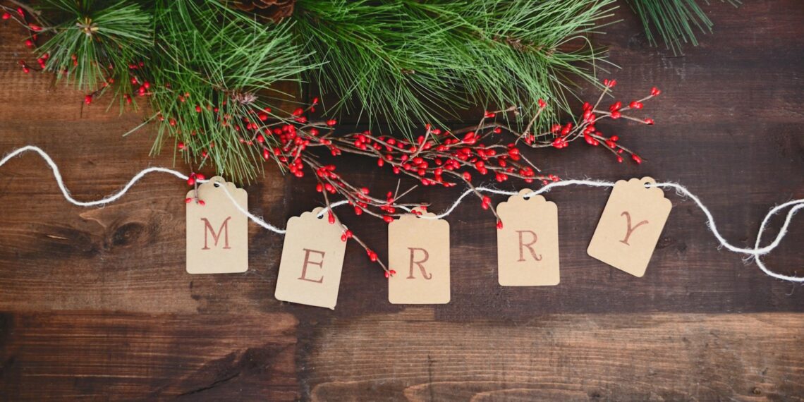 MERRY text cutout on white string by wreath