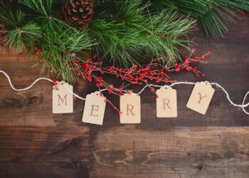 MERRY text cutout on white string by wreath
