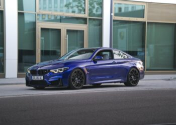 blue bmw m 3 coupe parked near white building during daytime