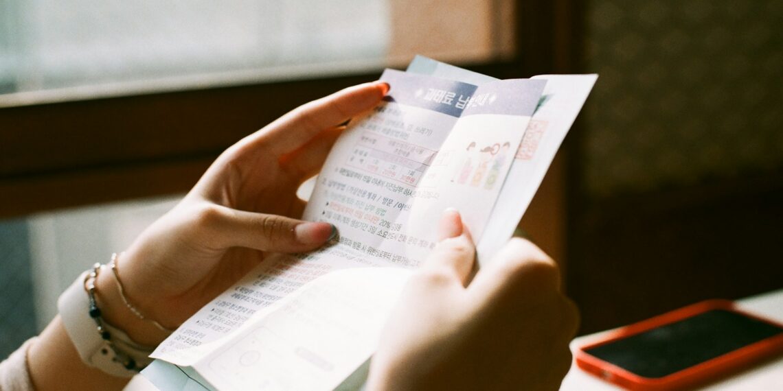 person holding white printer paper