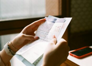 person holding white printer paper
