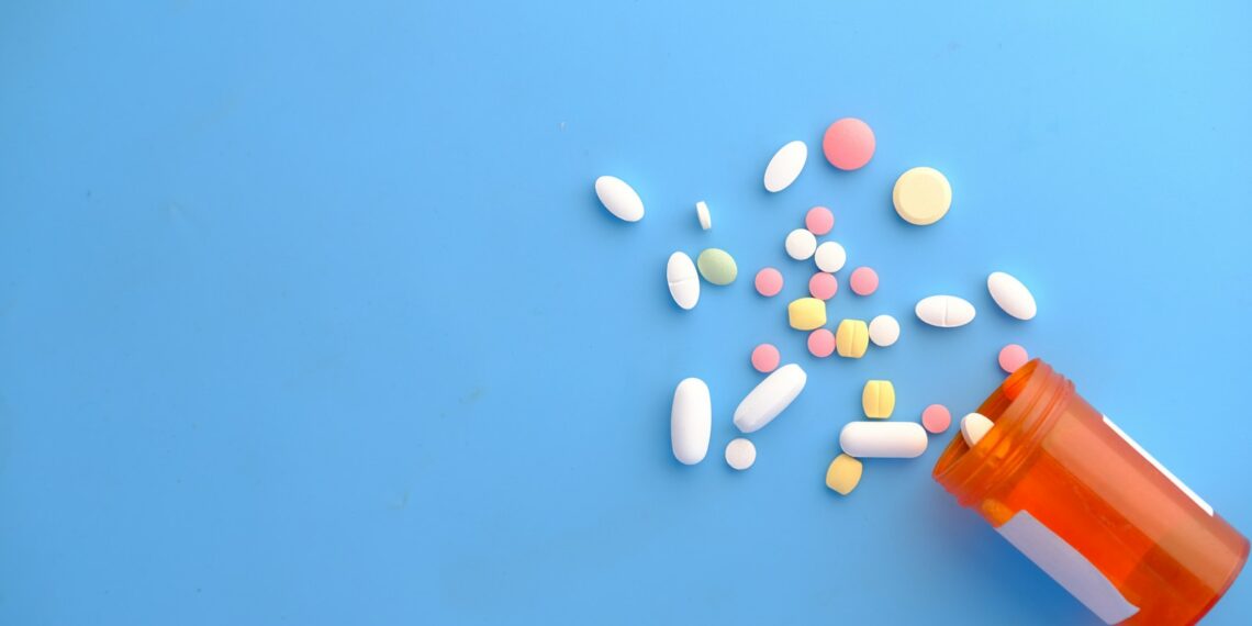 orange and white medication pill