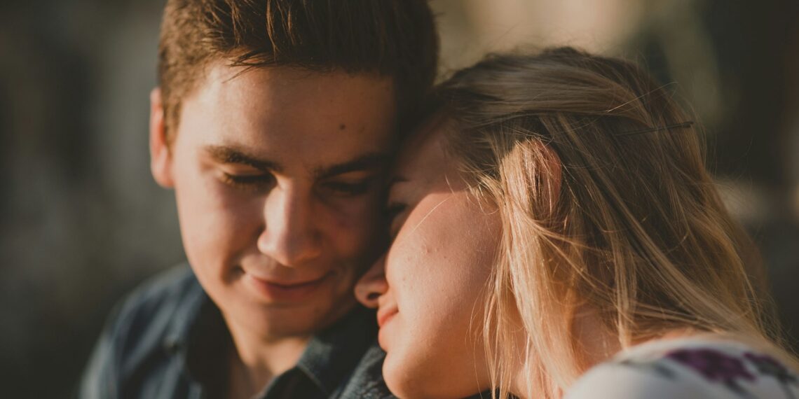woman leaning on man's shoulder