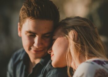 woman leaning on man's shoulder