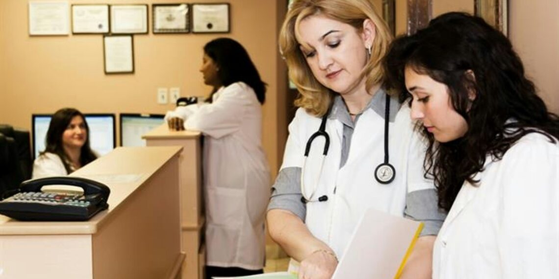 woman in white long sleeve shirt holding white printer paper