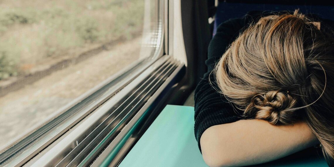 sleeping woman in train at daytime