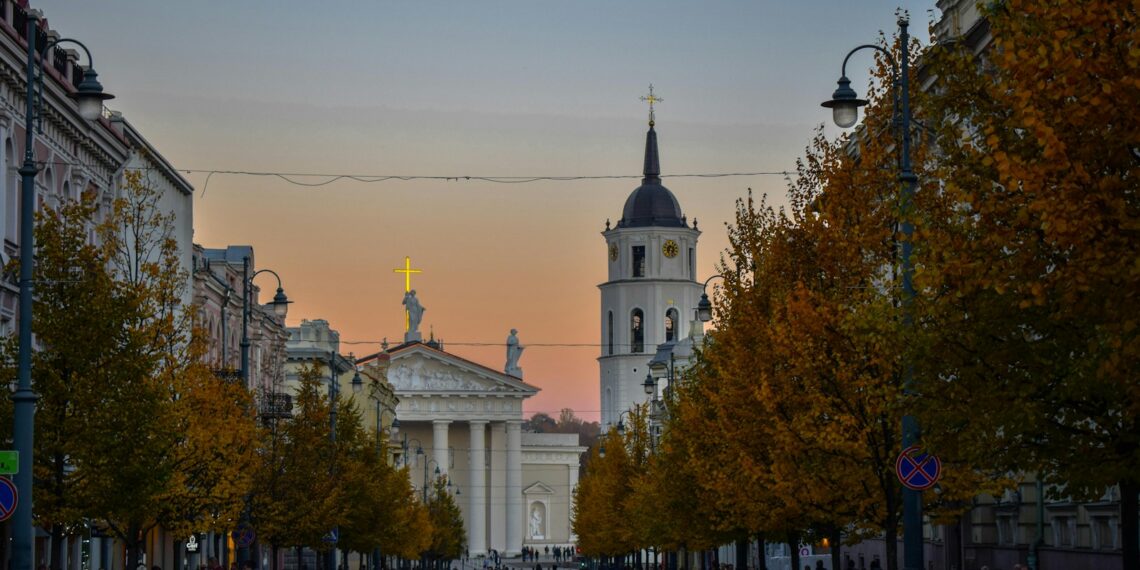 a group of people walking down a street next to tall buildings
