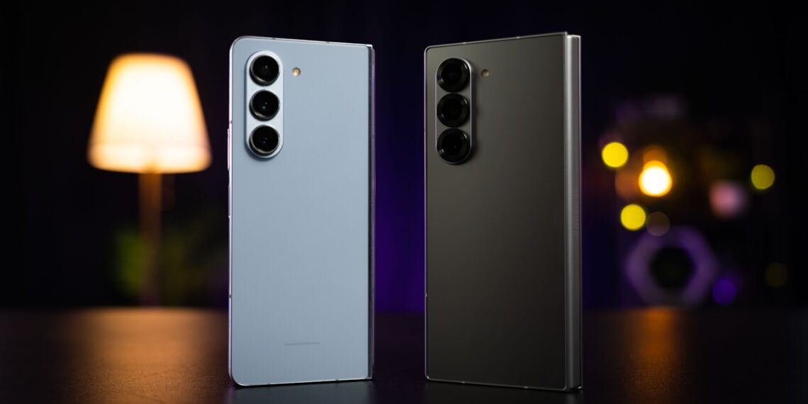 Two cell phones sitting next to each other on a table