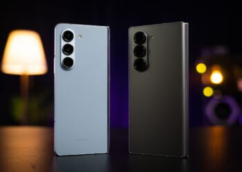 Two cell phones sitting next to each other on a table