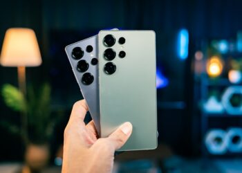 A person holding a remote control in their hand