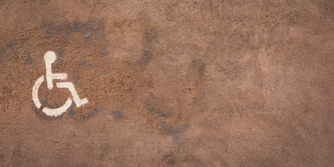 a handicap sign painted on the side of a wall