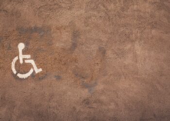 a handicap sign painted on the side of a wall