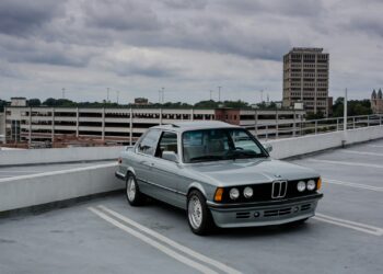 gray Mercedes-Benz coupe on parking building