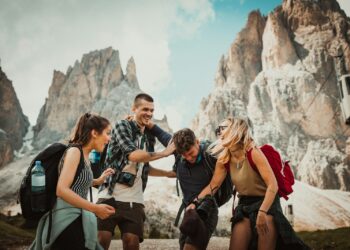 low-angle photography of two men playing beside two women