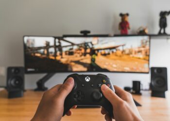 person holding black game controller